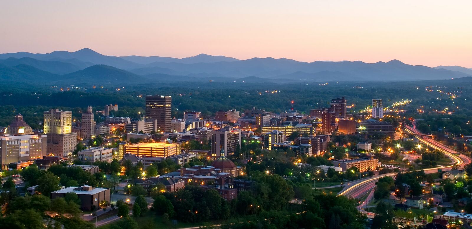 Asheville, North Carolina skyline at dusk with Blue Ridge Mountains